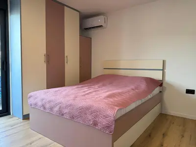 a bedroom with a bed with a pink blanket at Apartment Buena vista in Dobra Voda