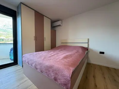 a bedroom with a bed and a window at Apartment Buena vista in Dobra Voda