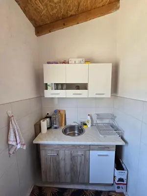 a kitchen with a sink and a counter top at Penthouse apartman Ogist Velika plaza Long beach near Ada Bojana in Donji Štoj