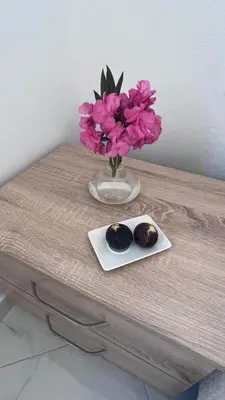 a table with a vase with purple flowers on it at Villa Giovanna in Donji Štoj