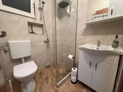 a bathroom with a toilet and a sink and a shower at Villa Giovanna in Donji Štoj