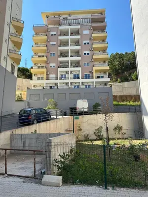 a large building with a car parked in front of it at Studio GRIGÓ in Budva