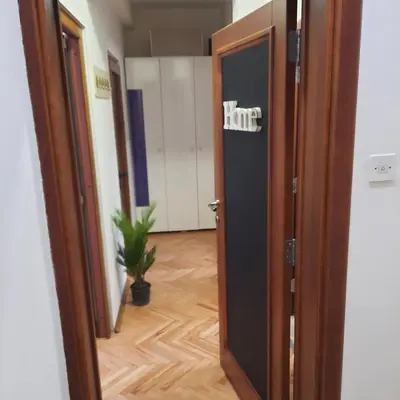 a door with the word hate written on it in a hallway at Apartman HOME Kotor in Kotor