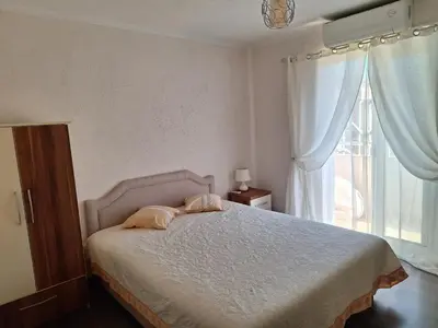 a bedroom with a bed with two pillows and a window at a cozy corner in Bar