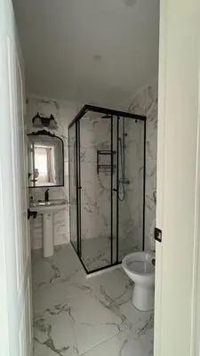 a bathroom with a shower and a toilet and a sink at Zaytoon Residence in Ulcinj