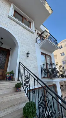 a house with a staircase and a balcony at Zaytoon Residence in Ulcinj