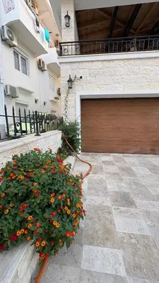 a garage door with a bunch of flowers in front of it at Zaytoon Residence in Ulcinj