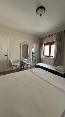 a bedroom with a large bed and a table at Zaytoon Residence in Ulcinj