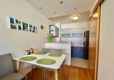 a small kitchen with a white table and chairs at Apartment Verdan in Bar