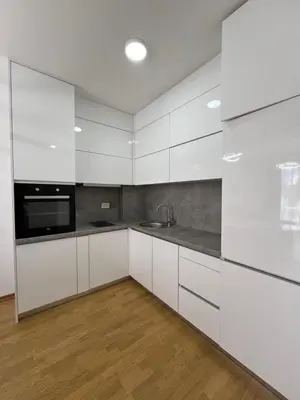 a kitchen with white cabinets and a sink at Tre Sorelle Becici in Becici