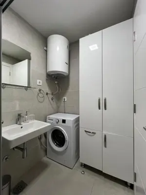 a bathroom with a washing machine and a sink at Tre Sorelle Becici in Becici
