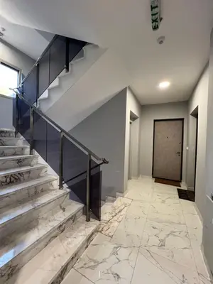 a staircase with marble floors and a door at Tre Sorelle Becici in Becici
