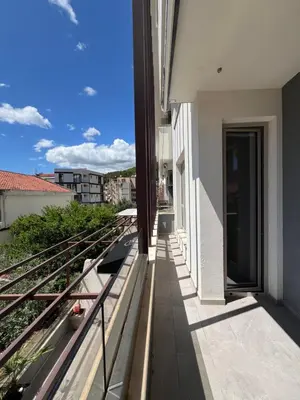a balcony with a view of a building at Tre Sorelle Becici in Becici