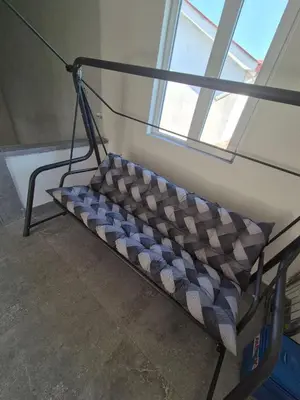 a bench sitting in a room with a window at Apartmani Nevena Airport in Mitrovići