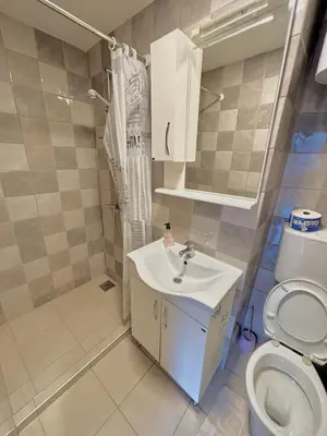 a small bathroom with a sink and a toilet at Balcony with Old Town view in Kotor