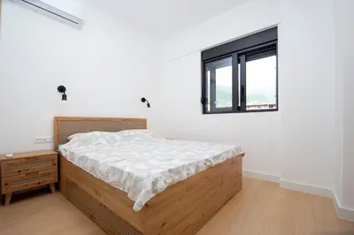 a bedroom with a bed and a window at Adriatic calm Terrace & Parking in Becici