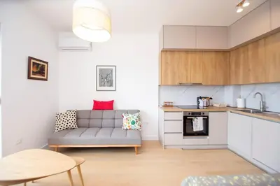 a living room with a couch and a kitchen at Adriatic calm Terrace & Parking in Becici