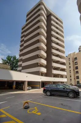 a car parked in a parking lot in front of a tall building at Adriatic calm Terrace & Parking in Becici