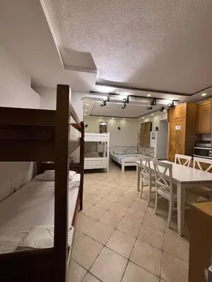 a room with bunk beds and a table and a kitchen at sar 1 balcony in Kotor
