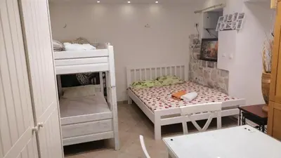 a small room with two bunk beds and a table at sar 1 balcony in Kotor