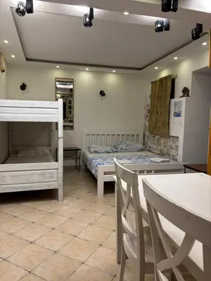 a room with two bunk beds and a table at sar 1 balcony in Kotor