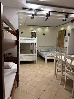 a room with two bunk beds and a table and chairs at sar 1 balcony in Kotor