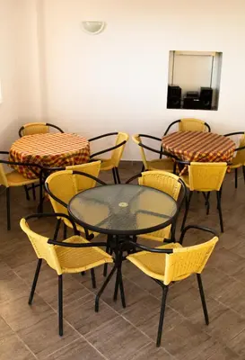 a group of tables and chairs in a room at Vila Kraljica Snežna in Kravlja