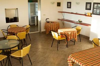 a dining room with tables and chairs and a counter at Vila Kraljica Snežna in Kravlja