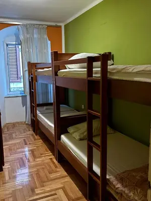 a room with three bunk beds in a room at sar 4 in Kotor