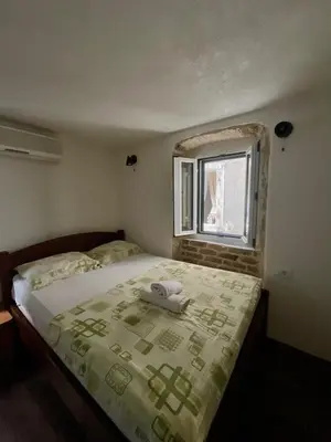 a bedroom with a bed with a phone on it at sar 4 in Kotor
