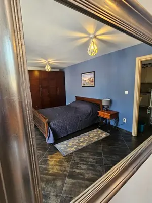 a bedroom with a bed and blue walls and a mirror at Charming Central Flat - Balcony with Mountain View, Near Beach in Budva