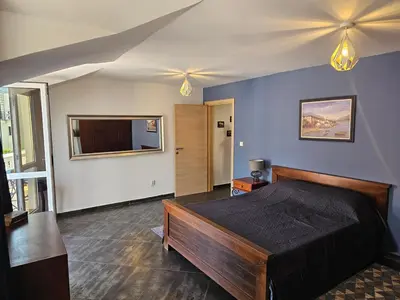 a bedroom with a bed and a tv in it at Charming Central Flat - Balcony with Mountain View, Near Beach in Budva