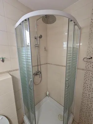 a shower with a glass enclosure in a bathroom at Charming Central Flat - Balcony with Mountain View, Near Beach in Budva