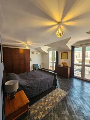 a bedroom with a bed and a ceiling with lights at Charming Central Flat - Balcony with Mountain View, Near Beach in Budva