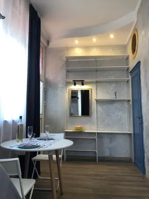 a room with a table and a mirror and shelves at Lucky Space 1 Nice&Cosy Studio in Budva
