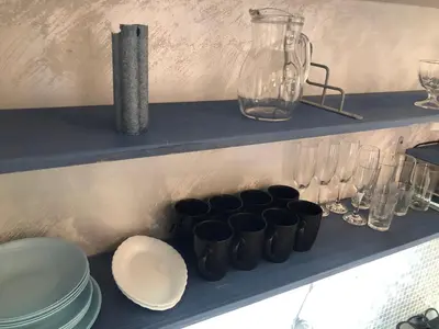 a shelf with bowls and glasses on it at Lucky Space 1 Nice&Cosy Studio in Budva