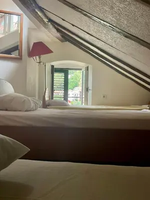 a large bed in a bedroom with a window at sar 6 in Kotor