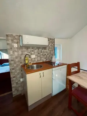 a small kitchen with a sink and a table at sar 6 in Kotor