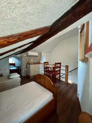 a bedroom with a bed and a dining room at sar 6 in Kotor