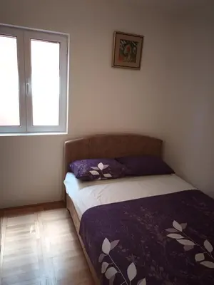 a bedroom with a bed and a window at Walk to the Sea-1 bedroom BUDVA in Budva