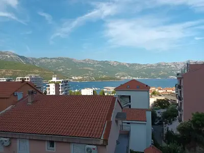 a view of the water from the roofs of buildings at Walk to the Sea-1 bedroom BUDVA in Budva