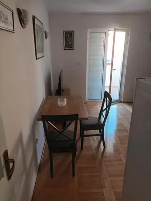 a dining room with a table and two chairs at Walk to the Sea-1 bedroom BUDVA in Budva