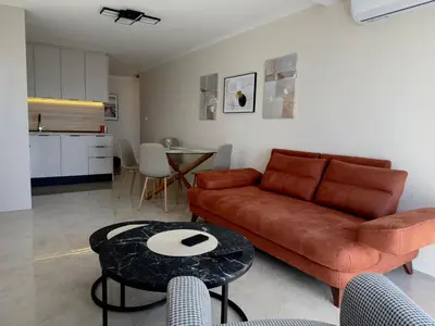 a living room with a couch and a table at Sunset Serenade Apartment