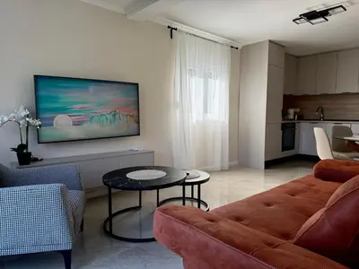 a living room with a couch and a table at Sunset Serenade Apartment