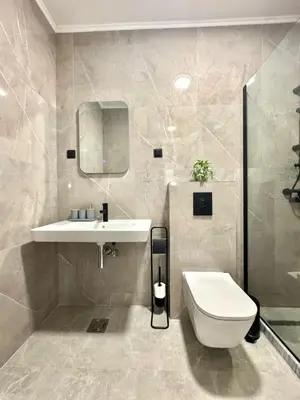 a bathroom with a white toilet and a sink at Sunny Bay Apartments in Budva