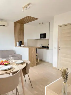 a kitchen and living room with a table and chairs at Montehome sea view in Becici