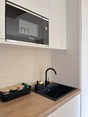 a kitchen counter with a sink and a microwave at Montehome sea view in Becici