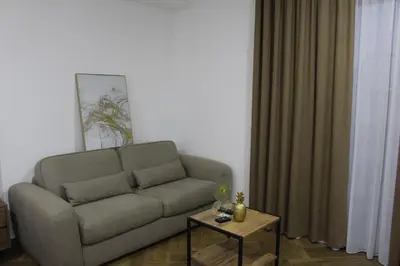 a living room with a couch and a table at AMD - garsonjera 312 in Dobra Voda