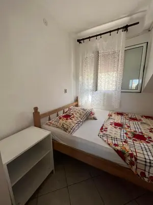 a bedroom with a bed and a window at Apartmani MiS in Dobra Voda