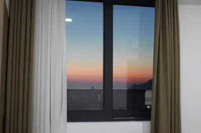 a window with a view of a sunset at AMD - stan 314 in Dobra Voda